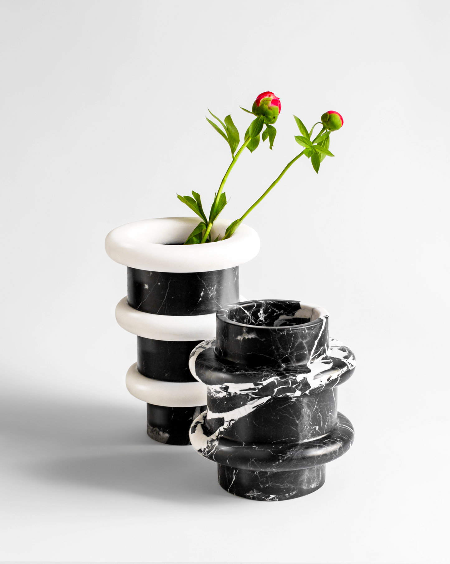Artisan crafted vase in Nero Marquina marble from Lumière collection arrangement with flowers designed by Sandro Lopez