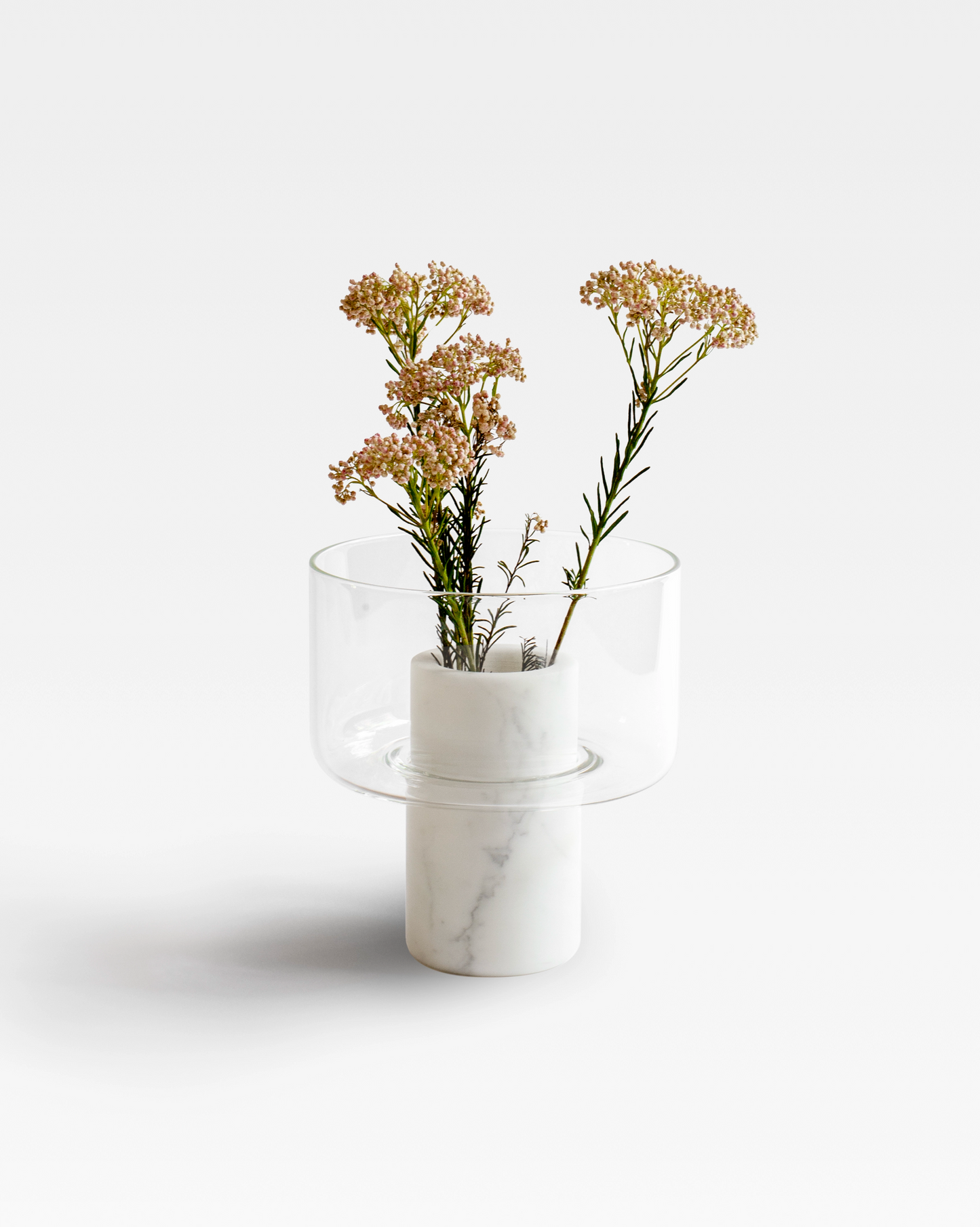 Abito vase crafted from handblown glass and white statuario marble