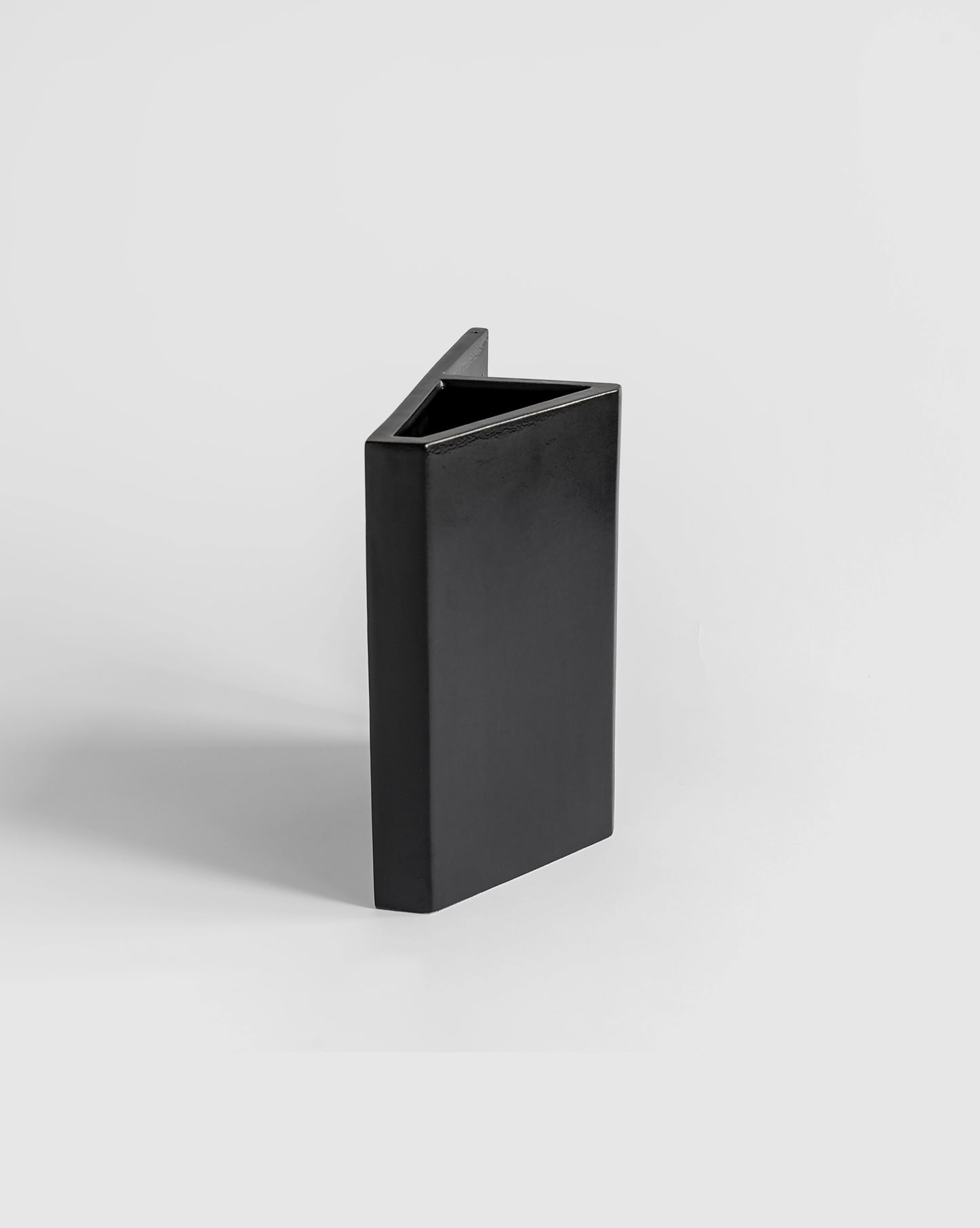 Black ceramic triangular Knight Vase with a matte finish, part of the Kish o Mat collection.