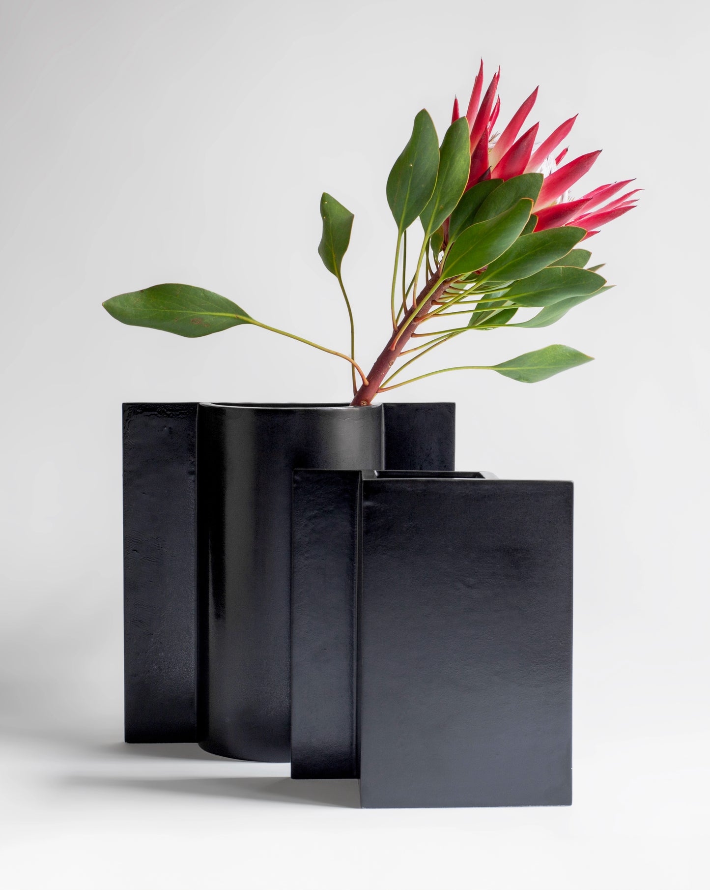 Still life of handcrafted ceramic minimalistic design vases with pink flower