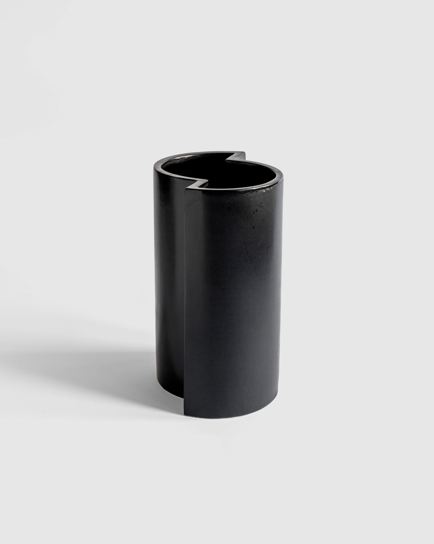 Sleek black ceramic Bishop Vase with a brutalist minimal design.