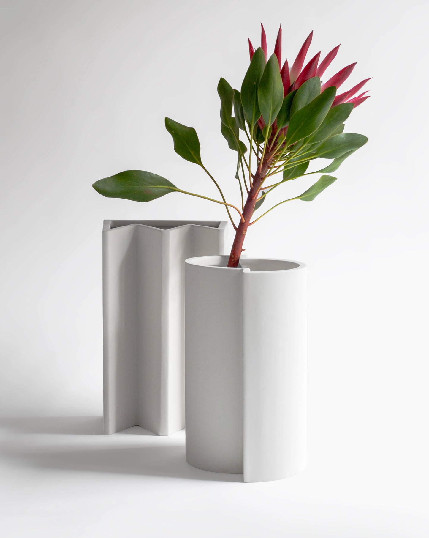 Stylish white ceramic vases, part of the chess-inspired Kish o Mat collection.