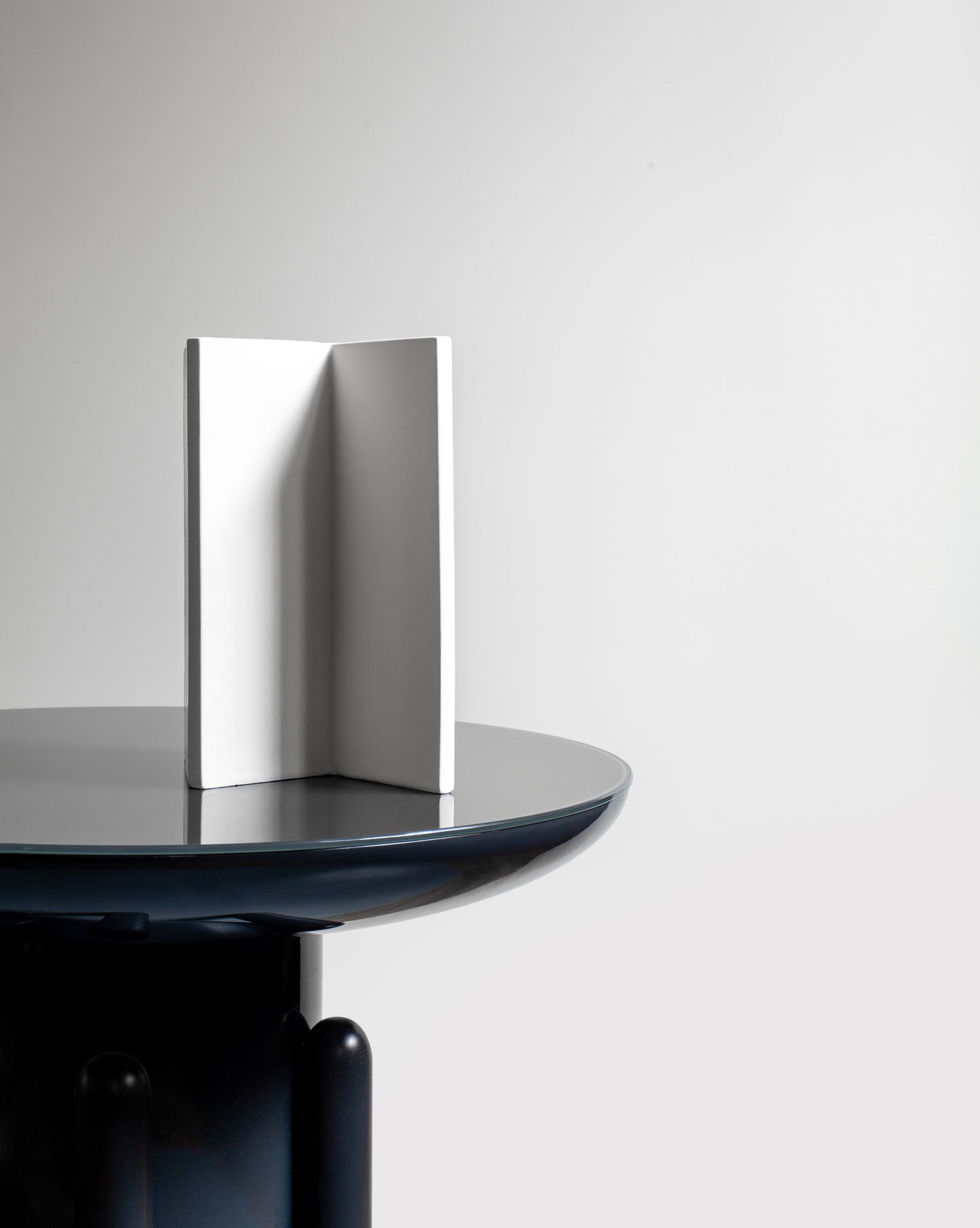 Sleek white Knight Vase with a geometric form from the Kish o Mat collection on a Jaime Hayon table