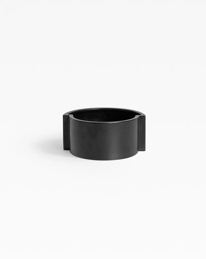 Handmade black ceramic bowl showcasing a sleek, contemporary aesthetic.