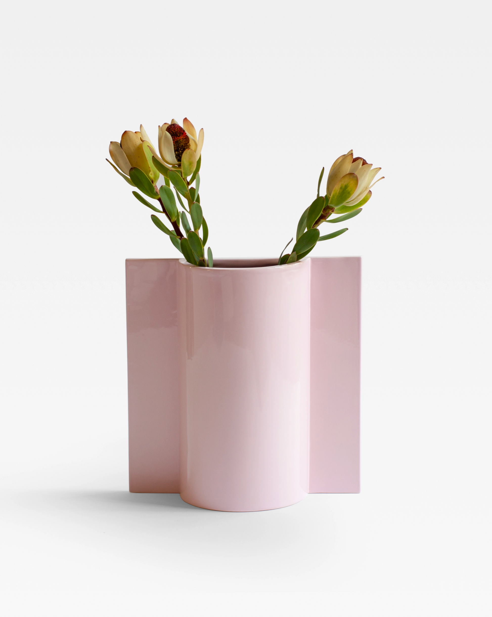 The Pink ceramic Queen Vase filled with flowers, emphasizing its versatility as both a functional and decorative piece for floral arrangements.