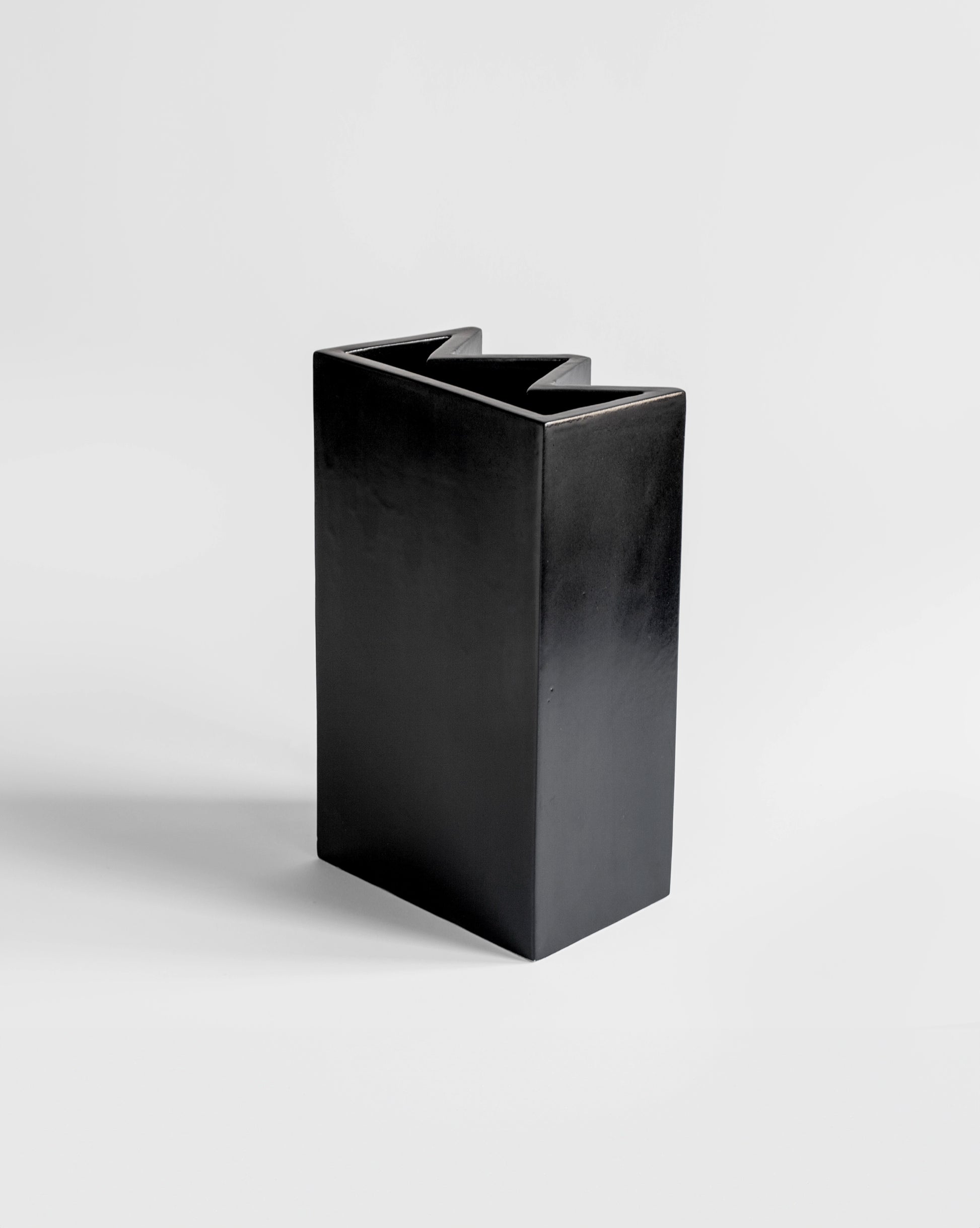 Modern matte black King Vase designed by artist Sara Khamisi with a brutalist aesthetics.