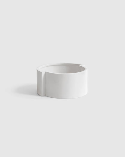 Modern white ceramic bowl with a minimalist design aesthetic.