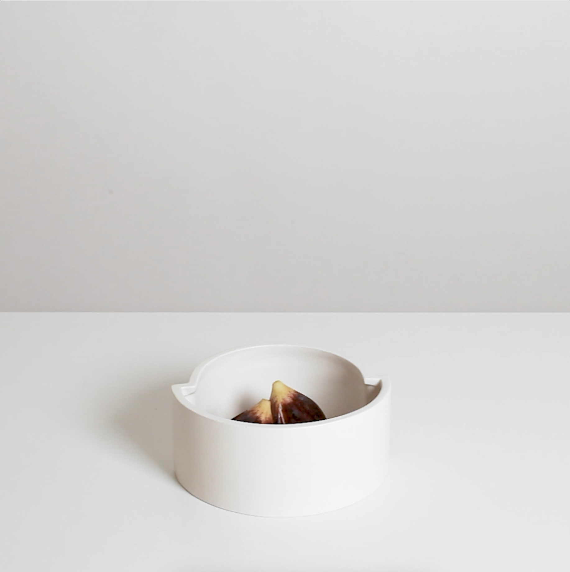 Video showcasing the modern handmade white ceramic fruit bowl with marble figs by Sandro Lopez Milano