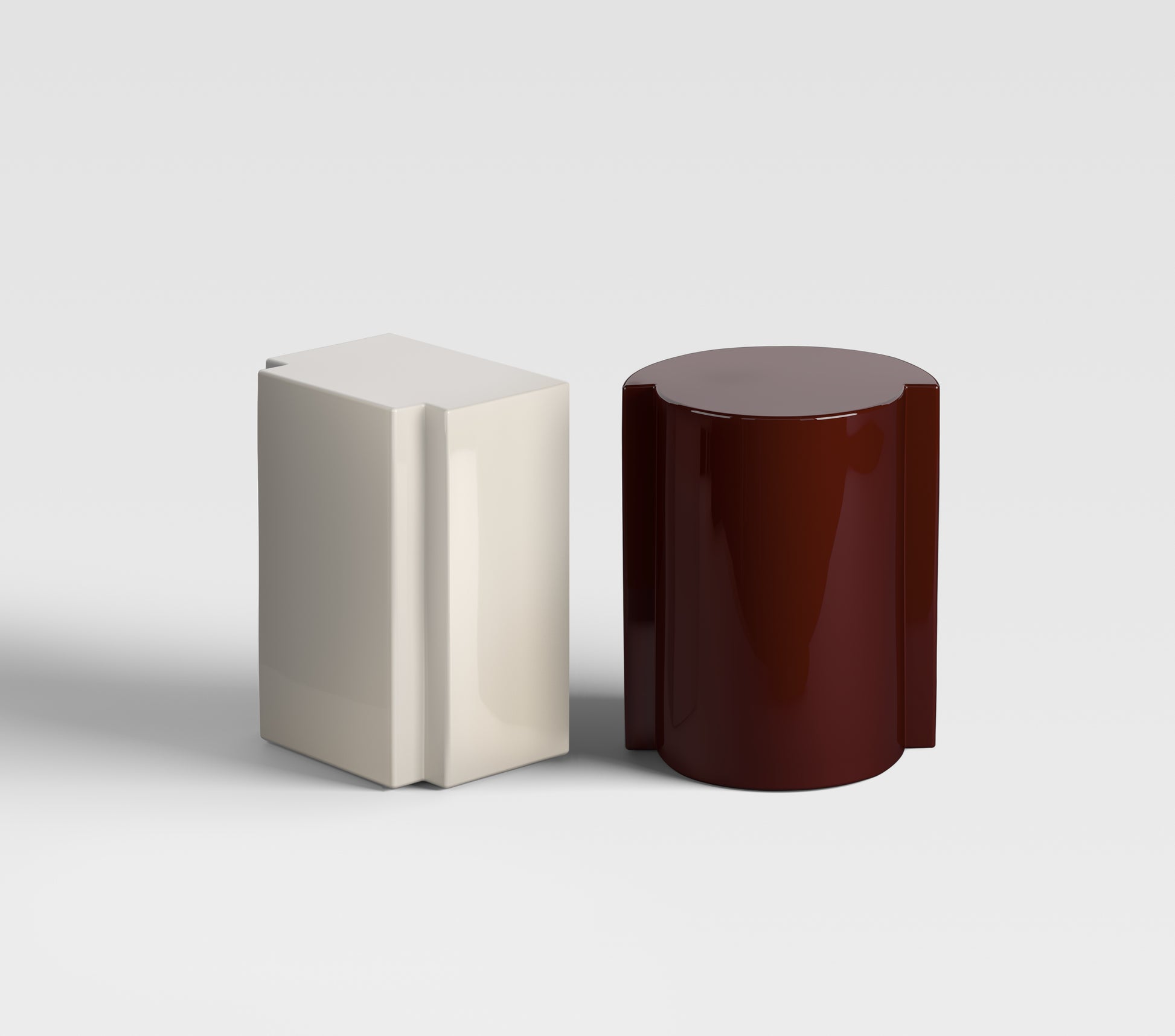 Lui in sand and Lei in burgundy lacquer, monolithic sculptural furniture made to order in Italy — elegant accents for modern interiors.