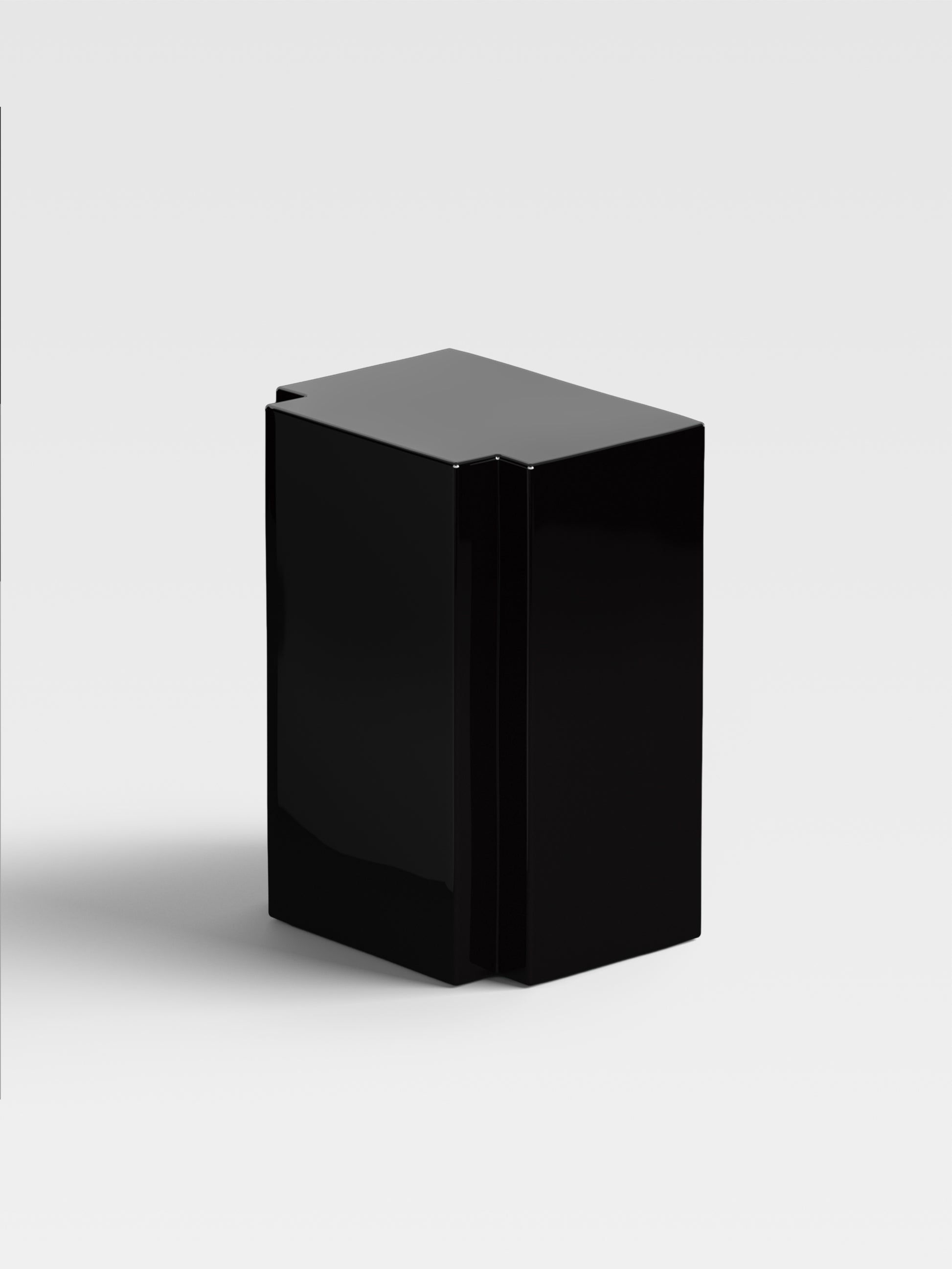 Angled view of Lui black lacquer side table showing monolithic geometry and artistic craftsmanship for contemporary living rooms.