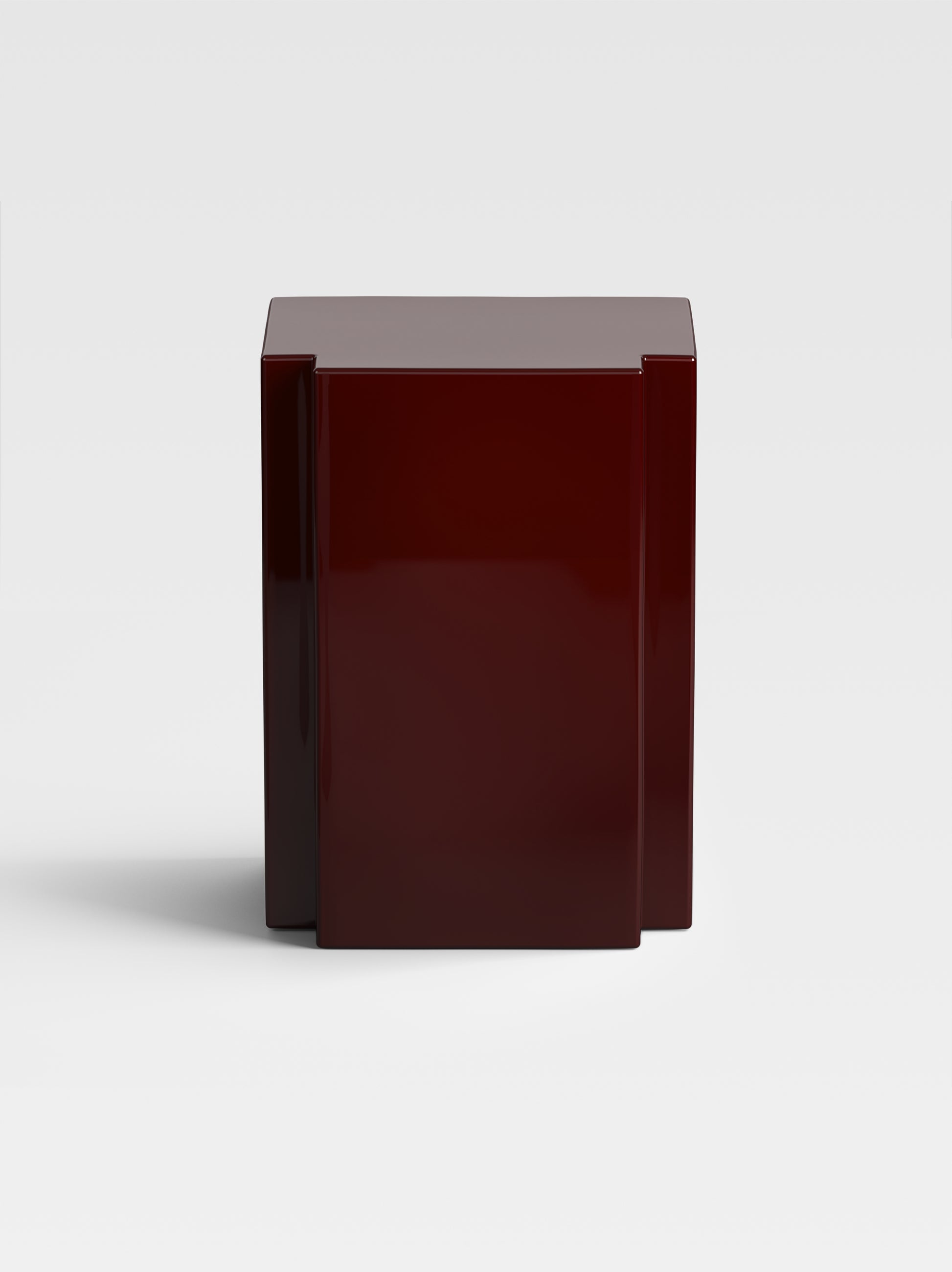 Lui side table in deep burgundy lacquer, sculptural luxury design made in Italy — a statement piece for modern and artistic interiors.