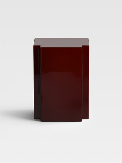 Lui side table in deep burgundy lacquer, sculptural luxury design made in Italy — a statement piece for modern and artistic interiors.