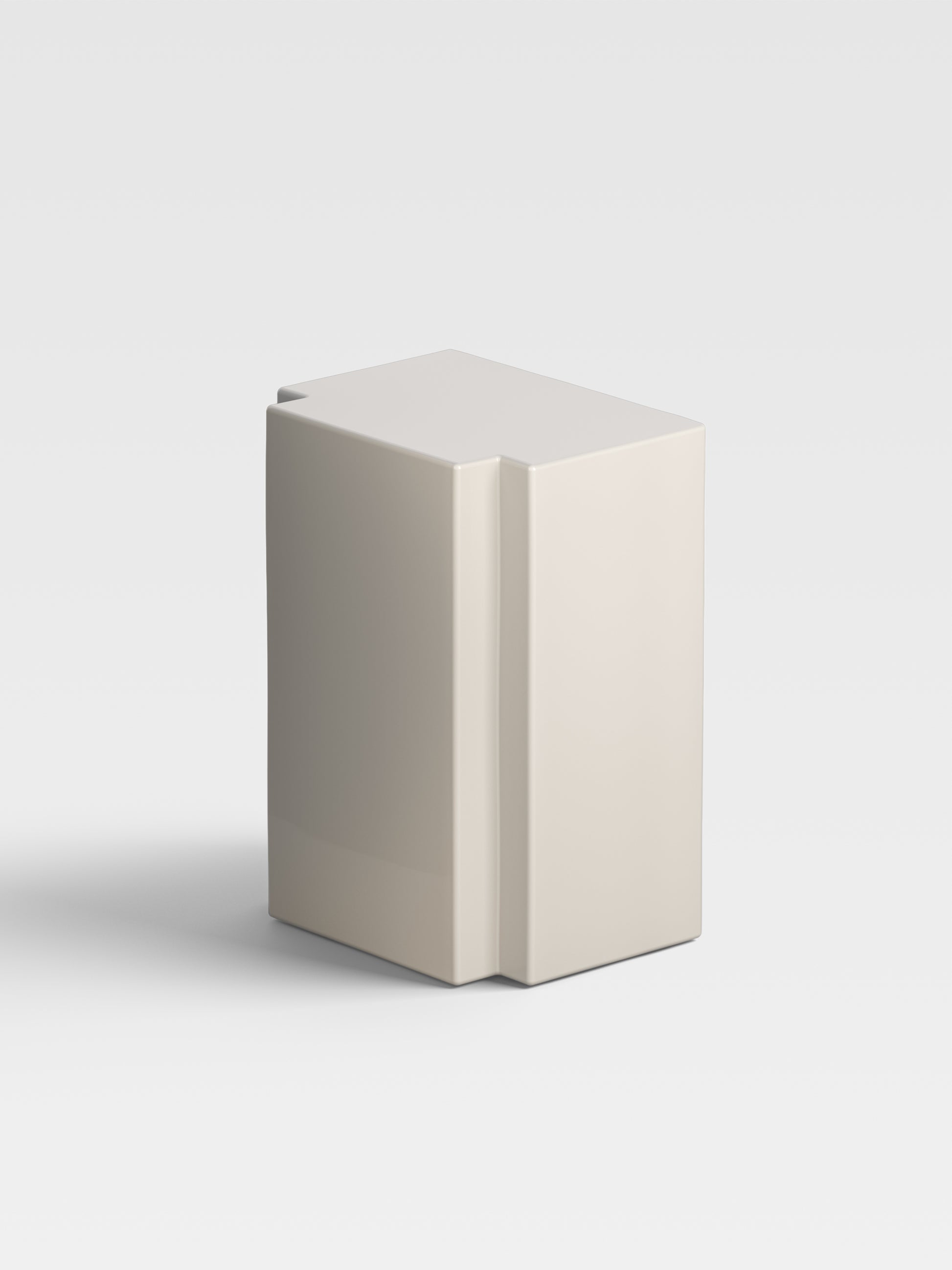 Angled view of Lui in sand finish, showing its monolithic geometry and artistic precision, collectible furniture from Milan’s design culture.